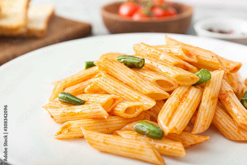 Tasty pasta with tomato sauce on plate, closeup