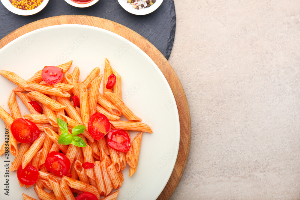 Plate with tasty pasta on grey background