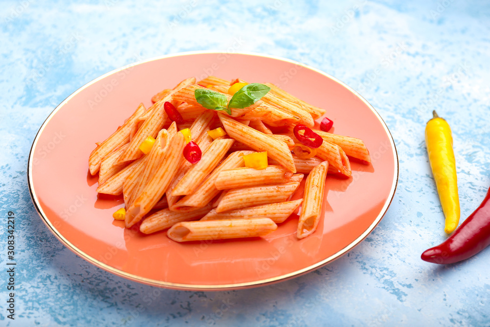 Plate with tasty pasta on color background