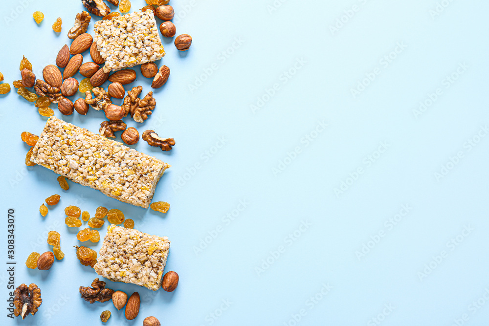 Tasty granola bars on color background