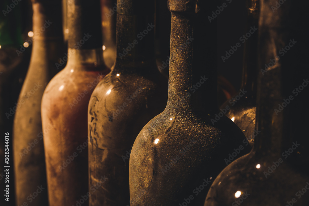 Bottles of wine in dark cellar, closeup