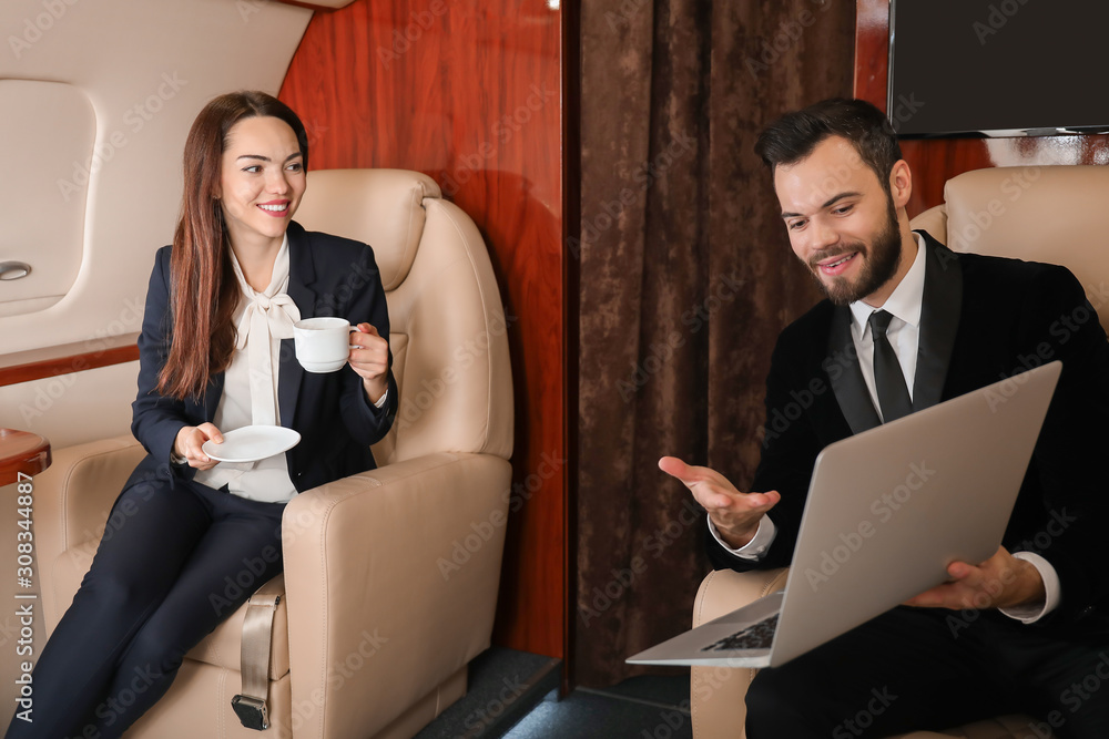 Business colleagues on board the modern private airplane