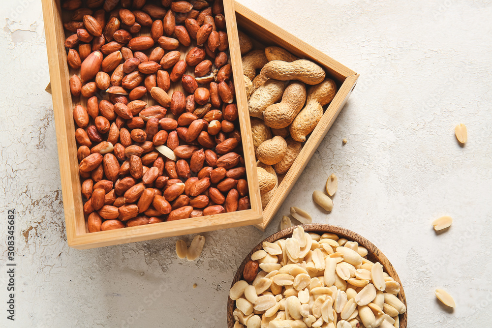 Boxes with peanuts on light background