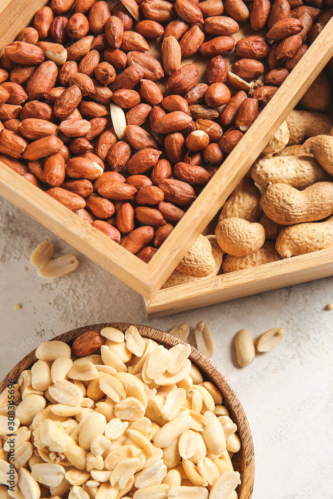 Boxes with peanuts on light background