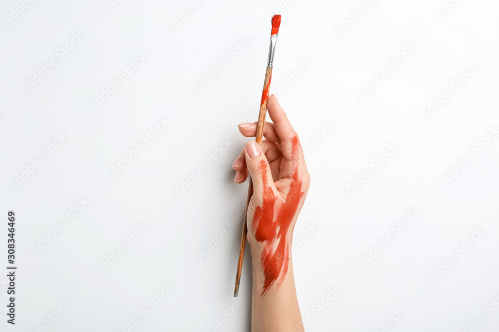 Artists hand with brush on white background