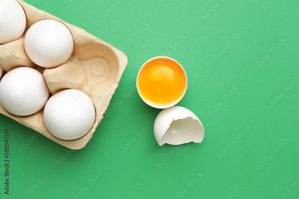 Fresh raw eggs on color background