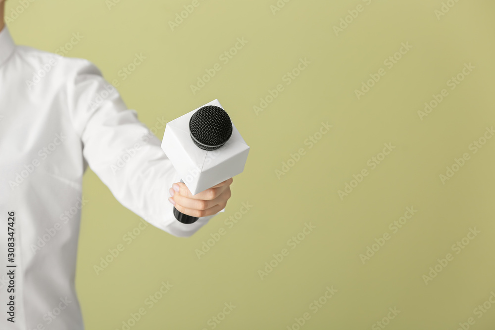 Journalist with microphone on color background