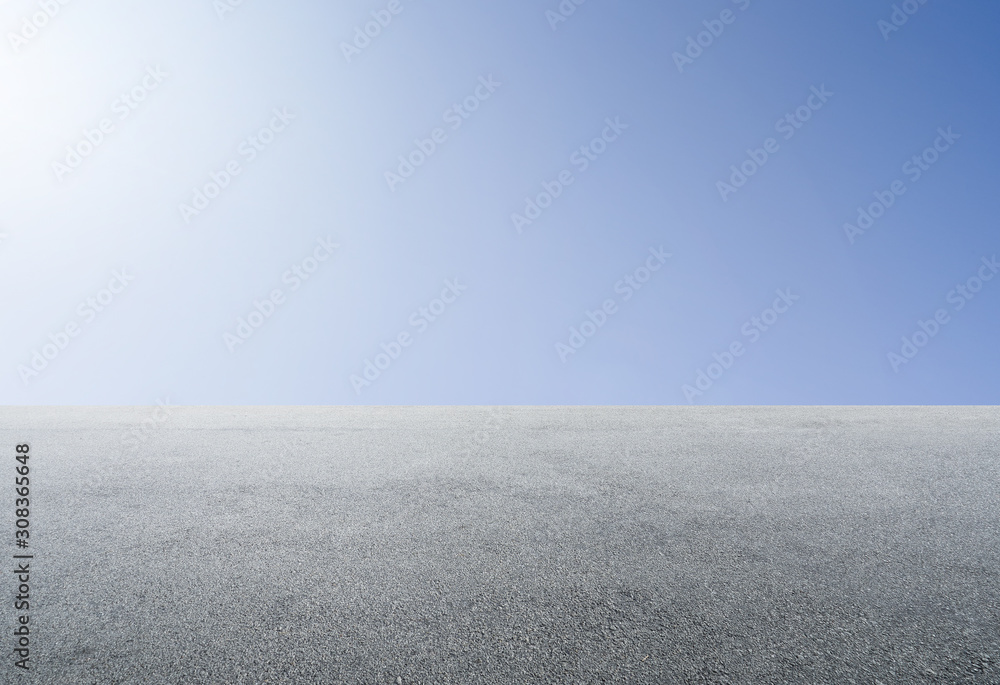 Empty asphalt floor with clear sunny sky