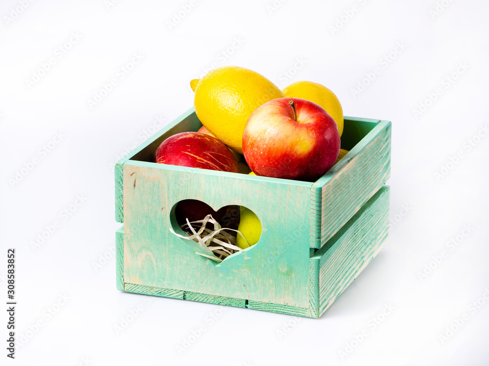 Fresh fruits in wooden box isolated on white background