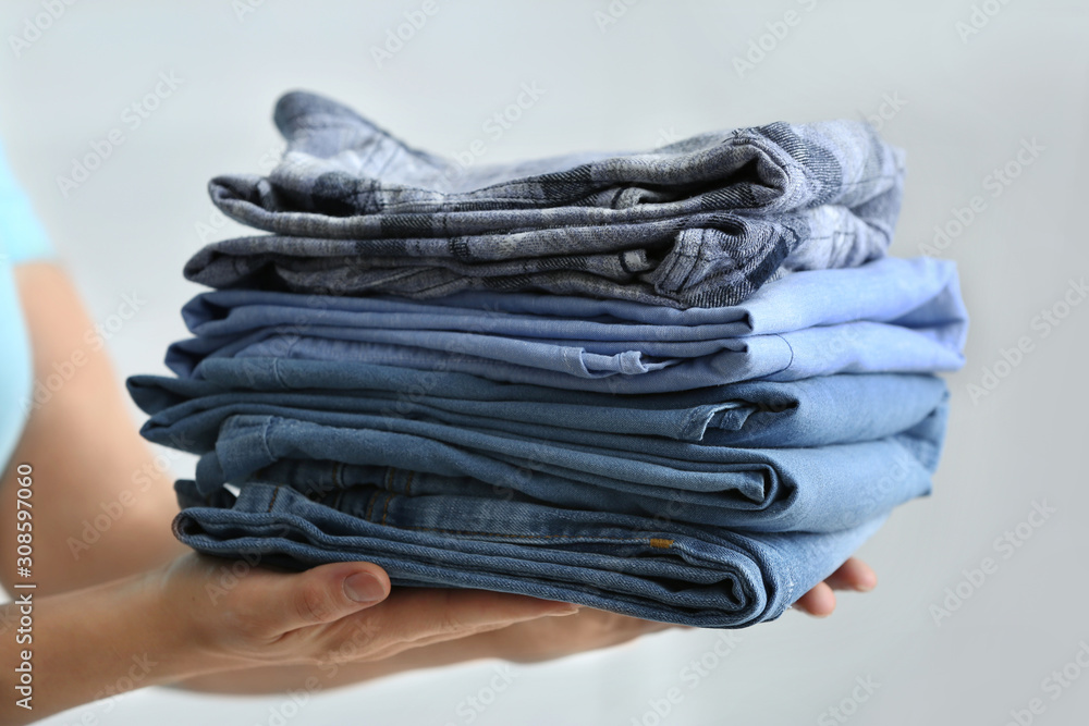 Woman with stack of clean clothes, closeup