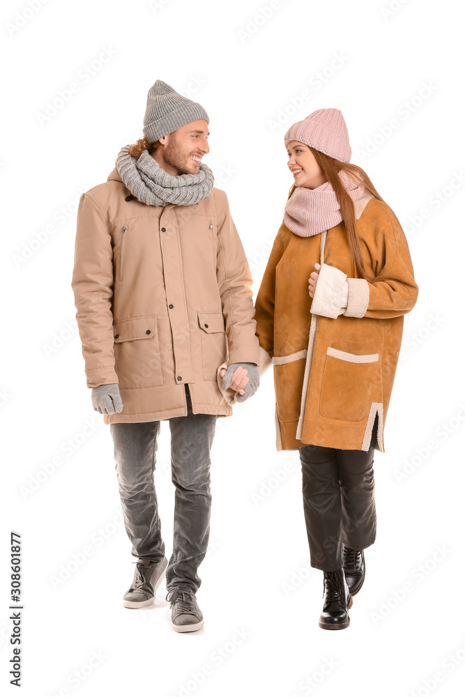 Happy couple in winter clothes on white background