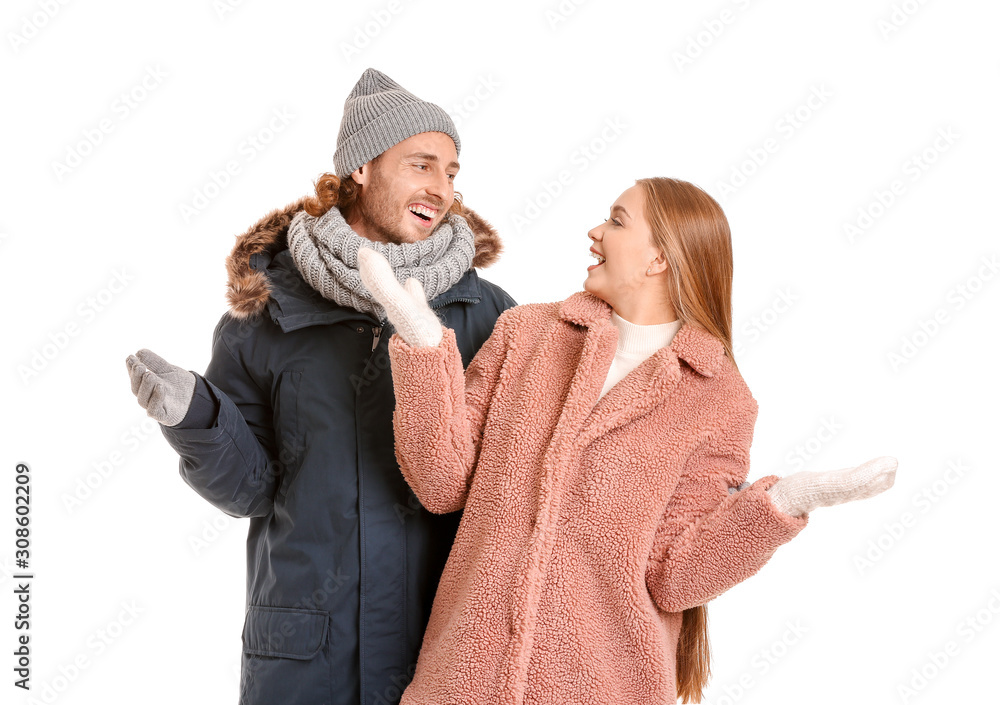 Happy couple in winter clothes on white background