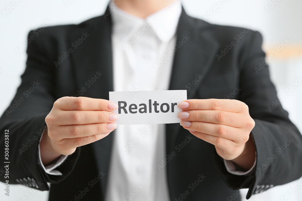 Real estate agent with paper sheet, closeup