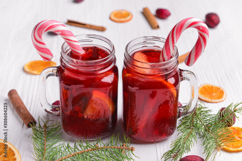 Mason jars of tasty mulled wine on white table