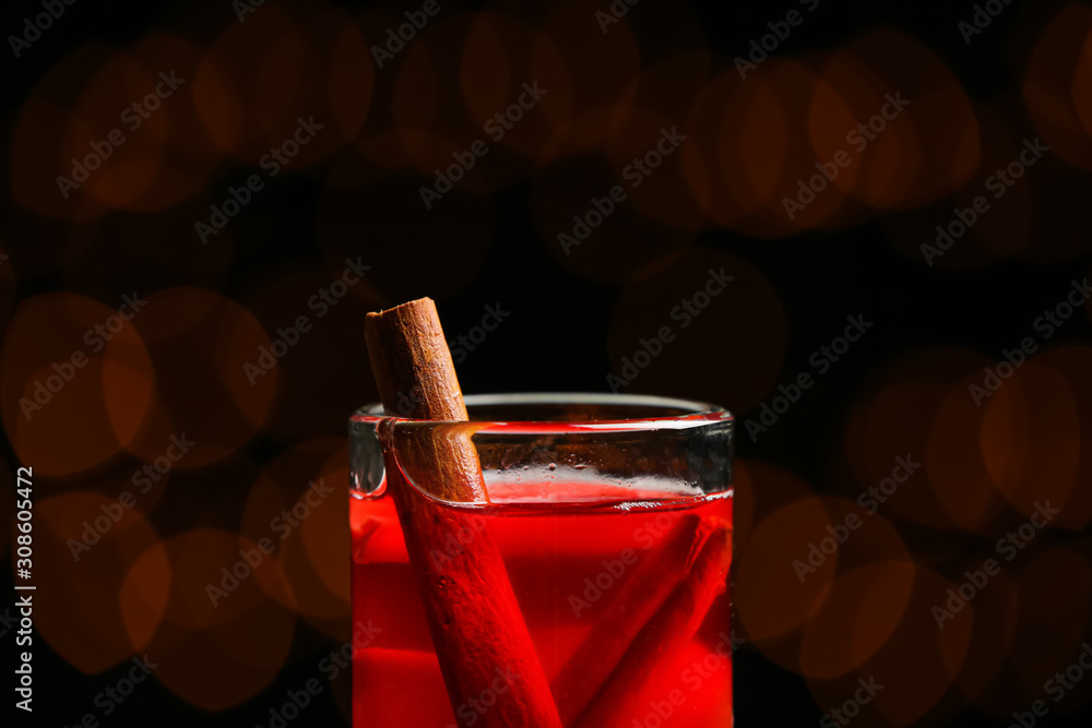 Glass of tasty mulled wine on dark background