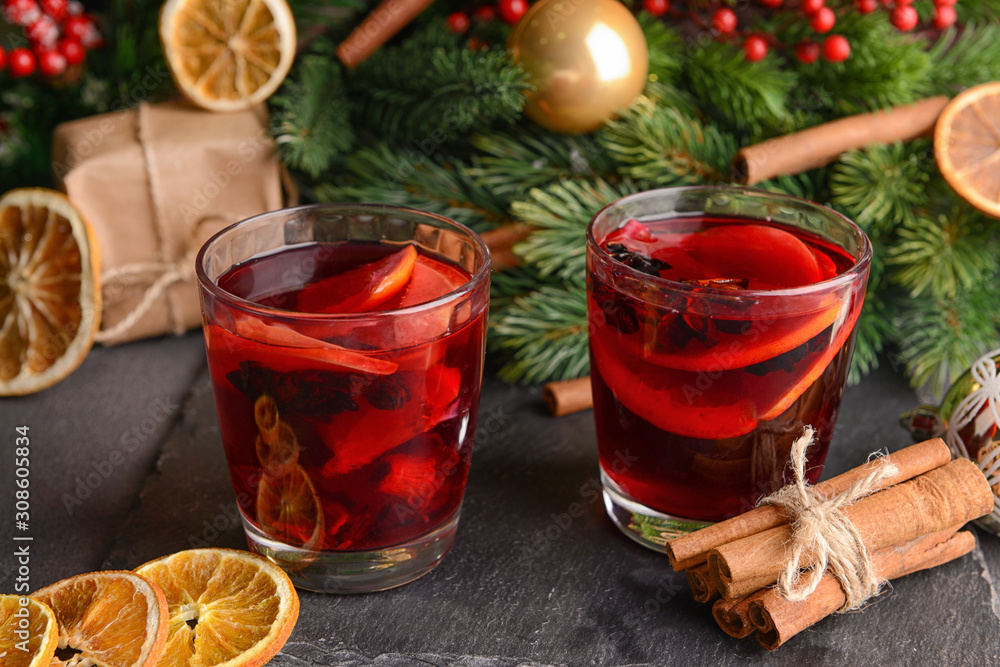 Christmas composition with tasty mulled wine on dark background