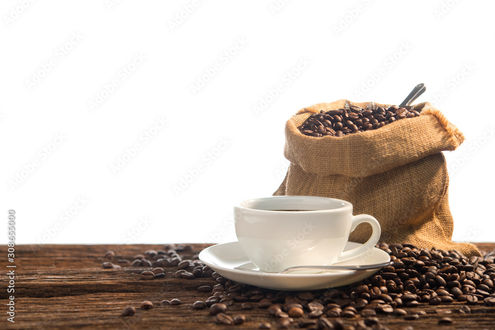 Cup of coffee and coffee beans on old wooden table isolated on white background