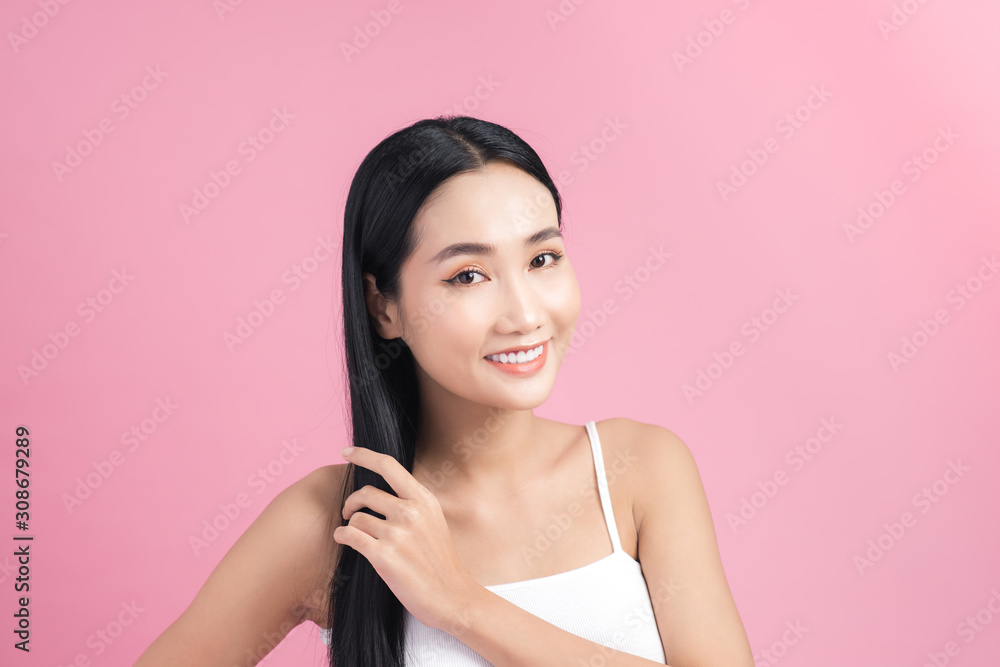 Young beautiful Asian woman taking care of her hair. Beauty portrait , natural make-up, beauty face,