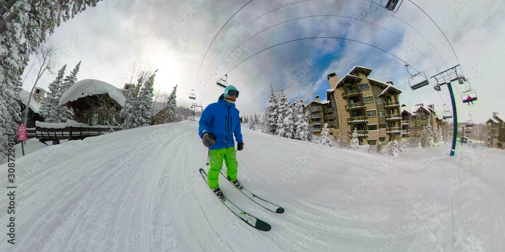 SELFIE: Male tourist enjoys skiing along the groomed piste under the ski lift.