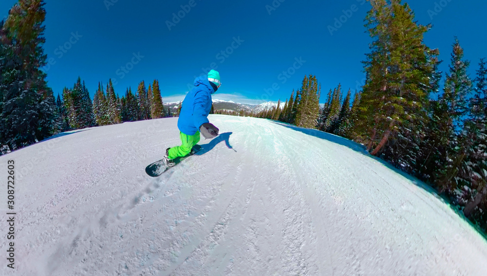 SELFIE: Unrecognizable snowboarder rides down a groomed trail on Copper Mountain