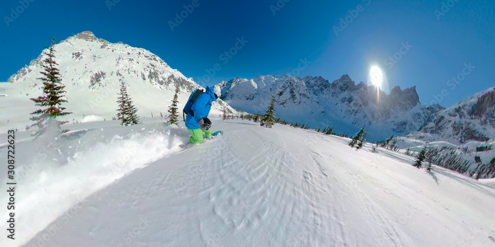 SELFIE: Unrecognizable snowboarder speeds down the ungroomed slope in Rockies.