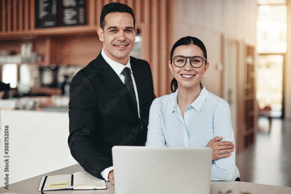 Smiling young businesspeople working together in a modern office