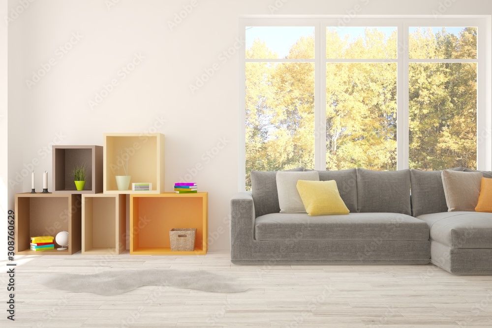 Stylish room in white color with sofa and autumn landscape in window. Scandinavian interior design. 