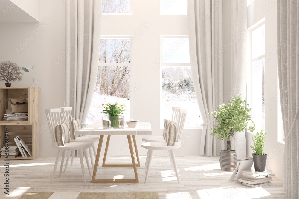 White stylish minimalist dinner room with winter landscape in window. Scandinavian interior design. 