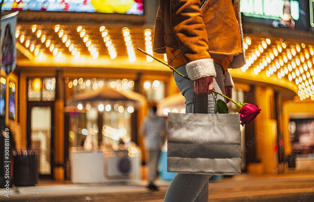 Young girl with a bag and a rose