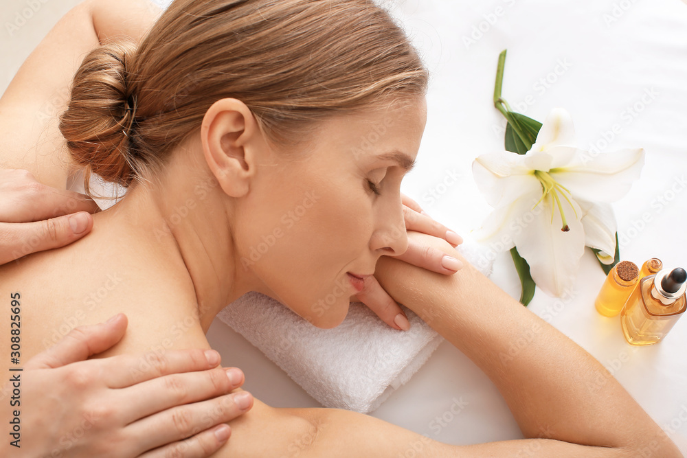 Beautiful woman receiving massage in spa salon