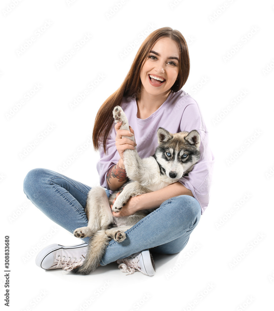 Cute woman with funny husky puppy on white background