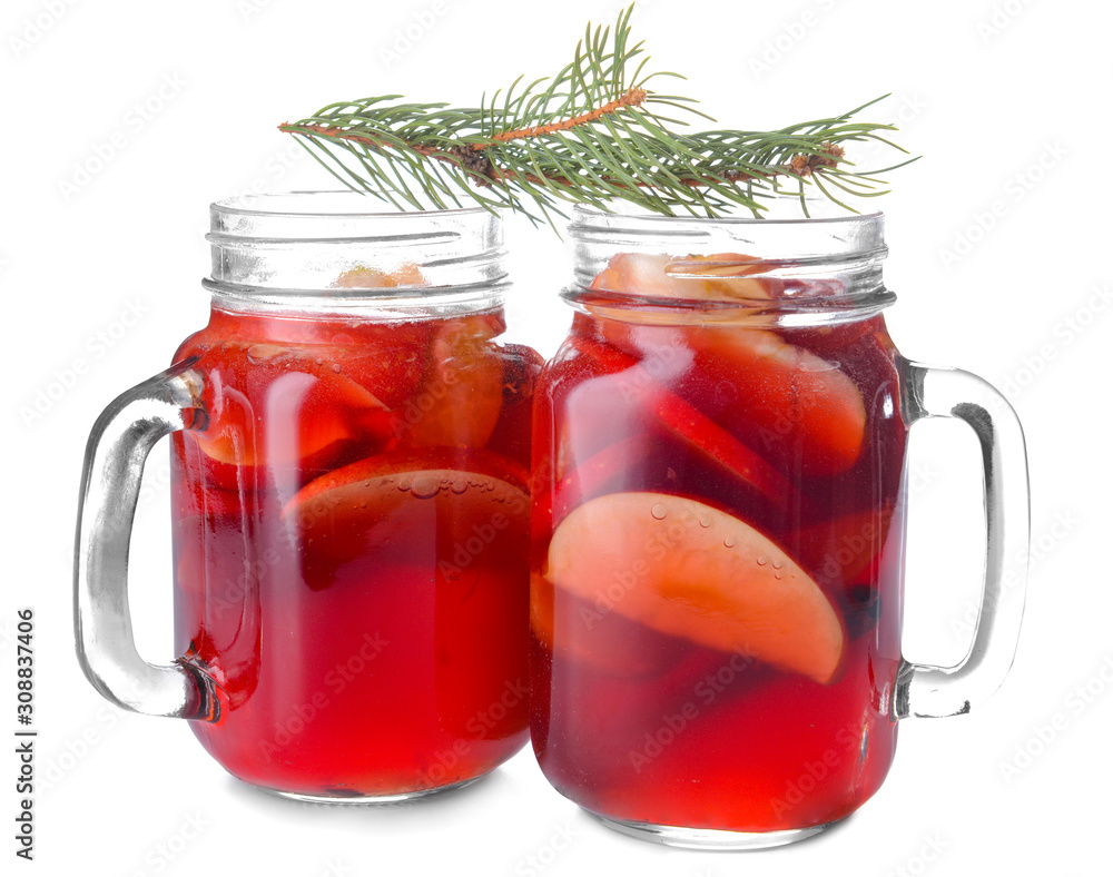 Mason jars of tasty mulled wine on white background