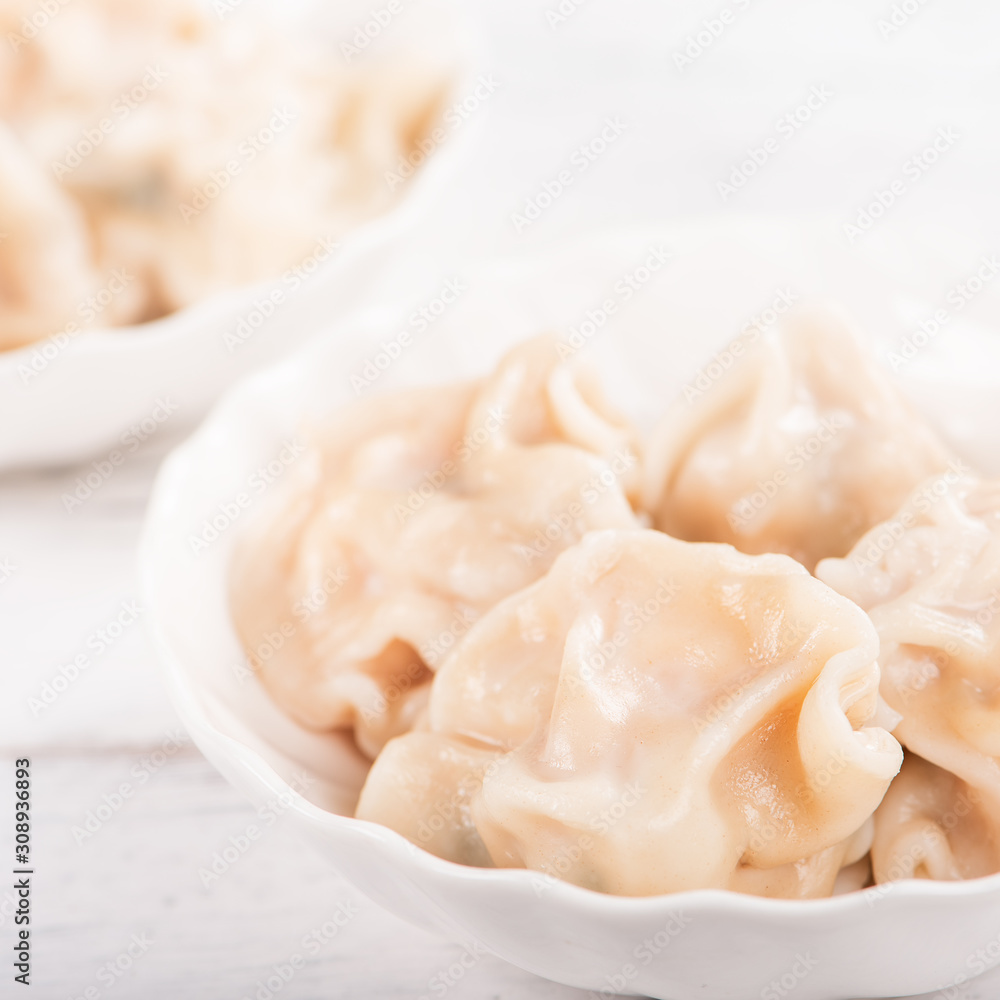 Fresh, delicious boiled pork gyoza dumplings, jiaozi on white background with soy sauce and chopstic