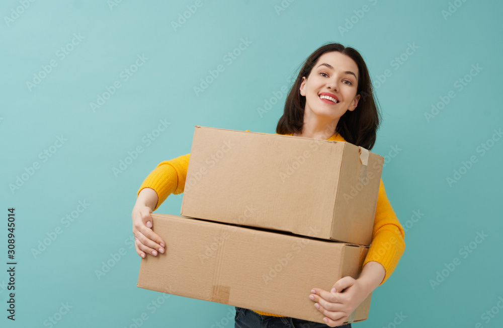 woman is holding cardboard box