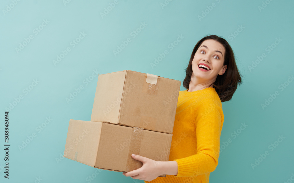 woman is holding cardboard box