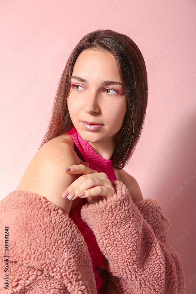 Fashionable young woman on color background