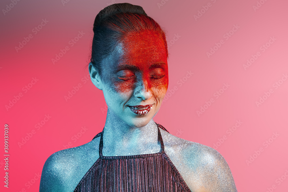 Beautiful woman with unusual makeup on color background