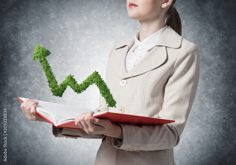 Businesswoman showing green plant shaped graph