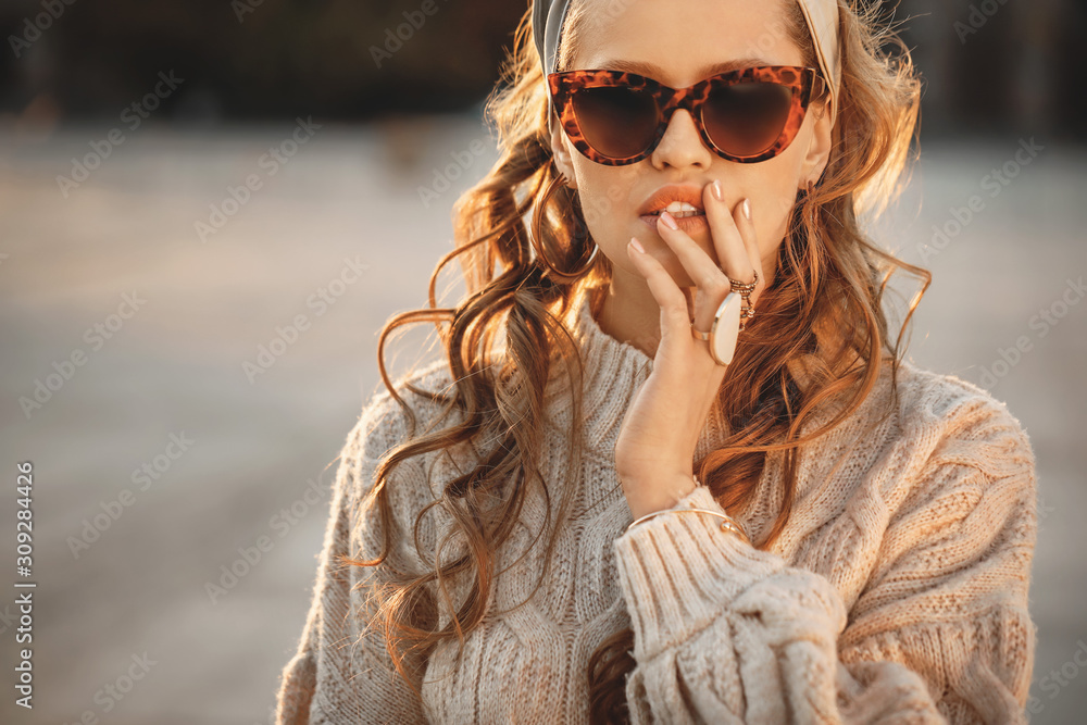 Beautiful fashionable young woman outdoors