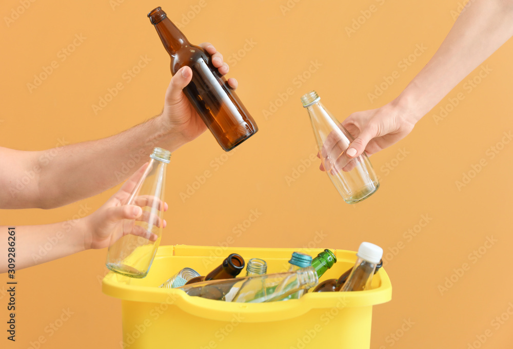 Family and container with garbage on color background. Concept of recycling