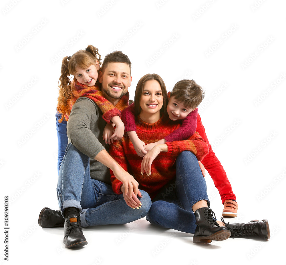 Happy family in winter clothes on white background