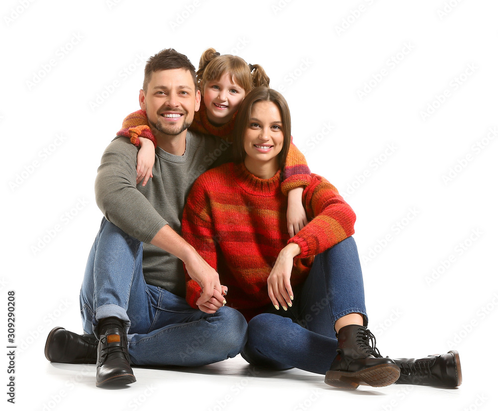 Happy family in winter clothes on white background