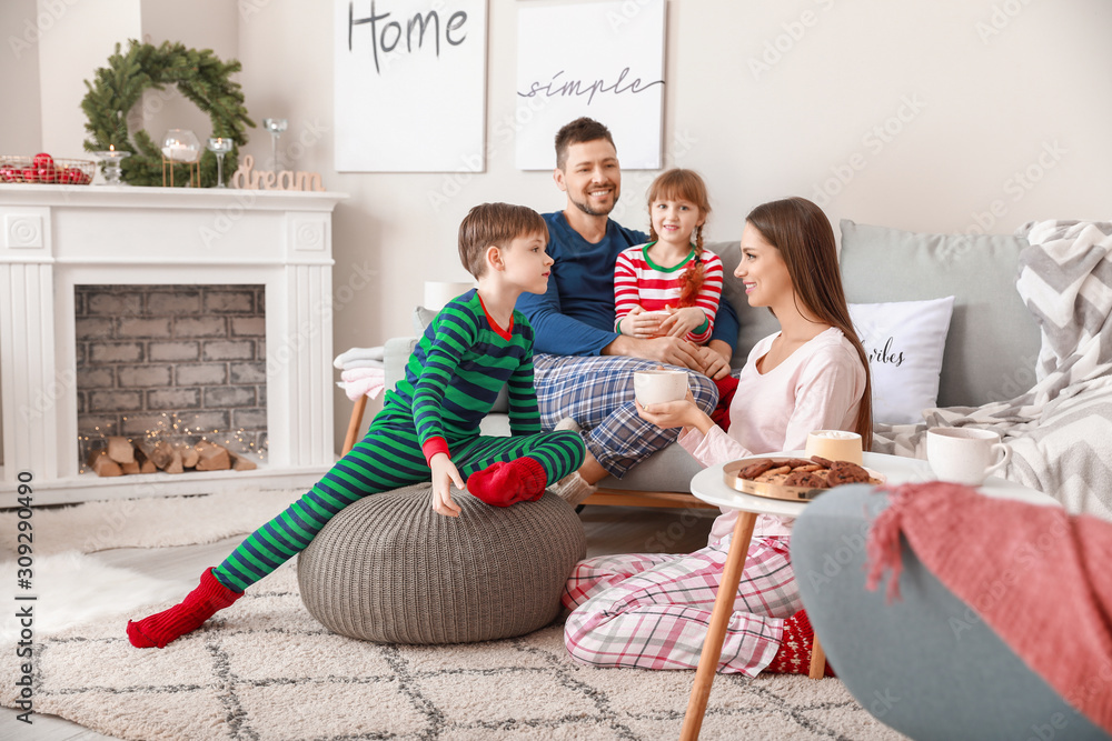 Happy family drinking hot tea at home