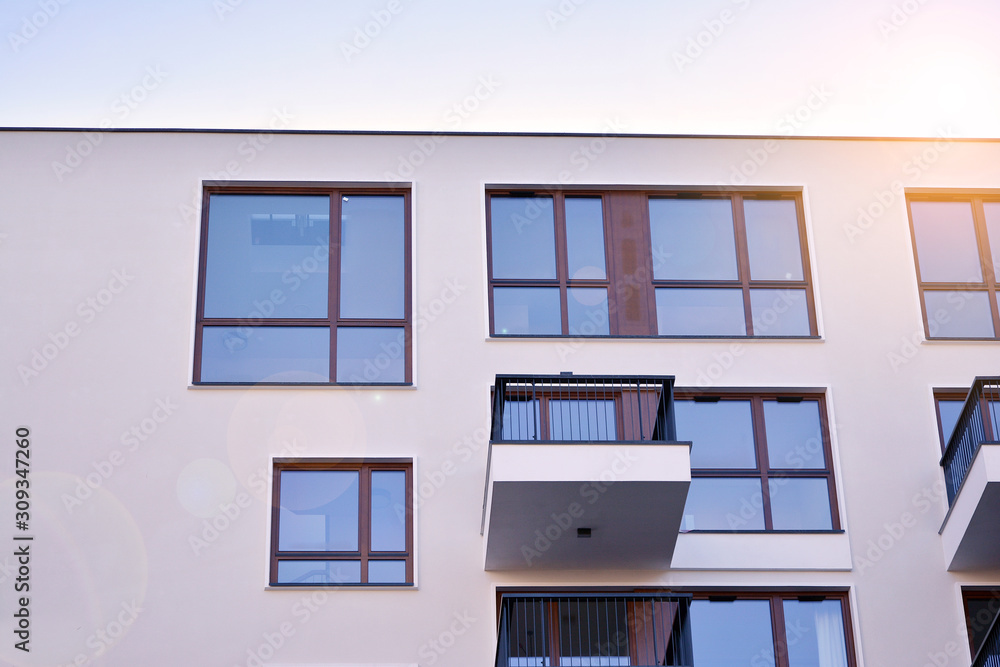 Sun rays light effects on urban buildings. Fragment of modern residential apartment with flat buildi