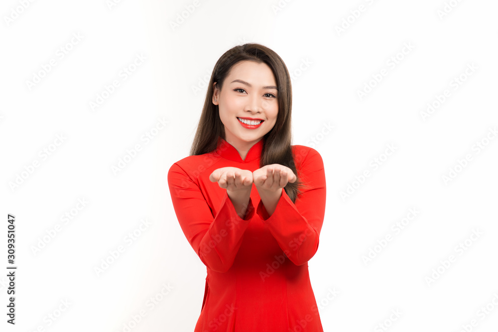 Happy lunar new year. Asian woman wearing traditional ao dai clothes portrait on white wall