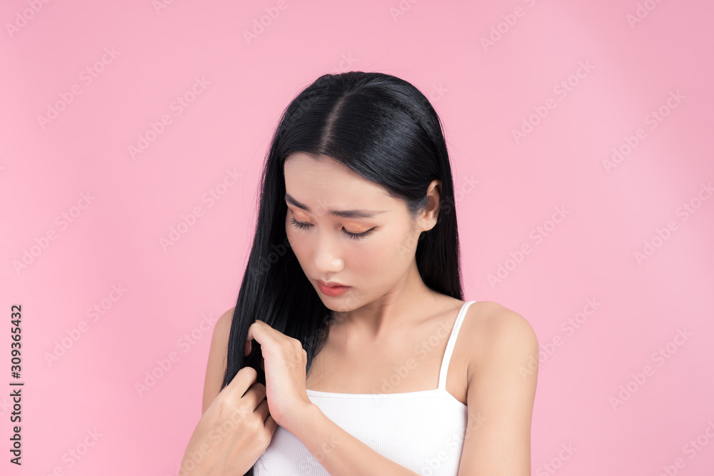 Young woman is dissatisfied with the state of their hair