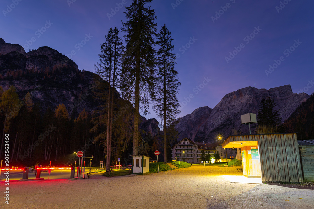 Parking at Lago di Braies lake and Seekofel peak at dawn, Dolomites. Italy