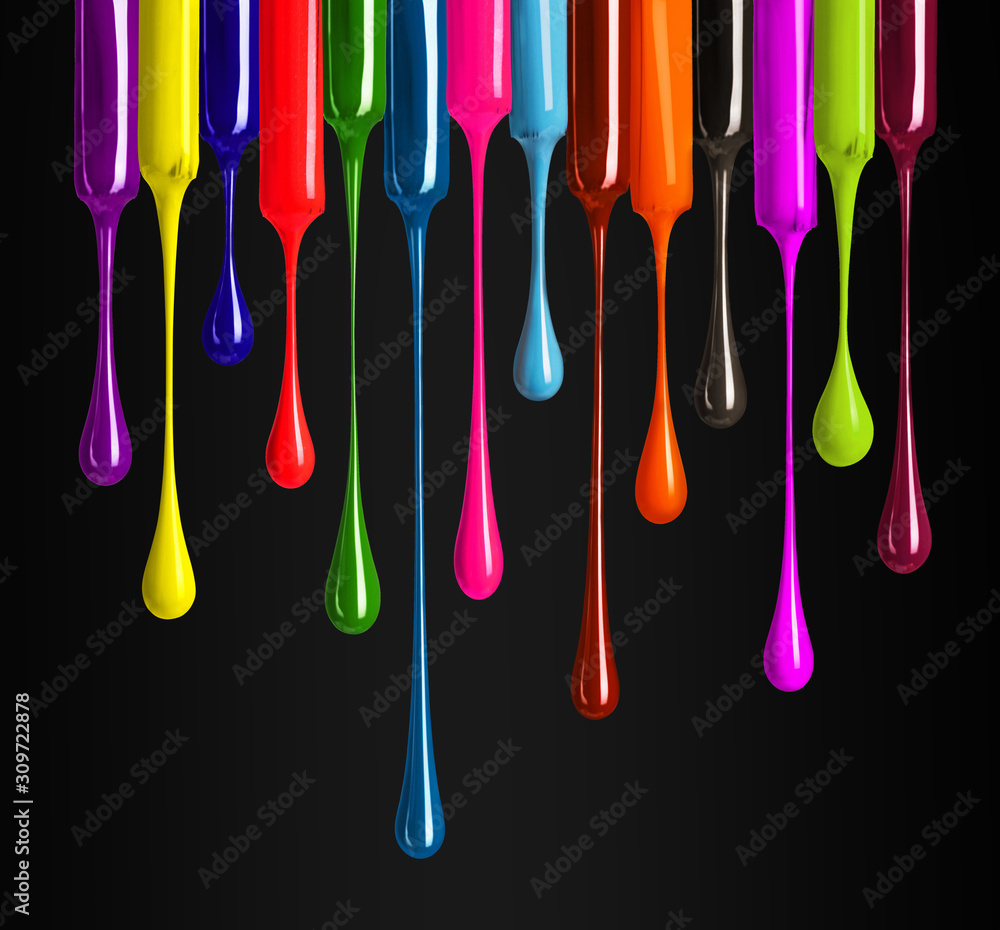 Colorful drops of nail polish drip from brushes close-up on black background