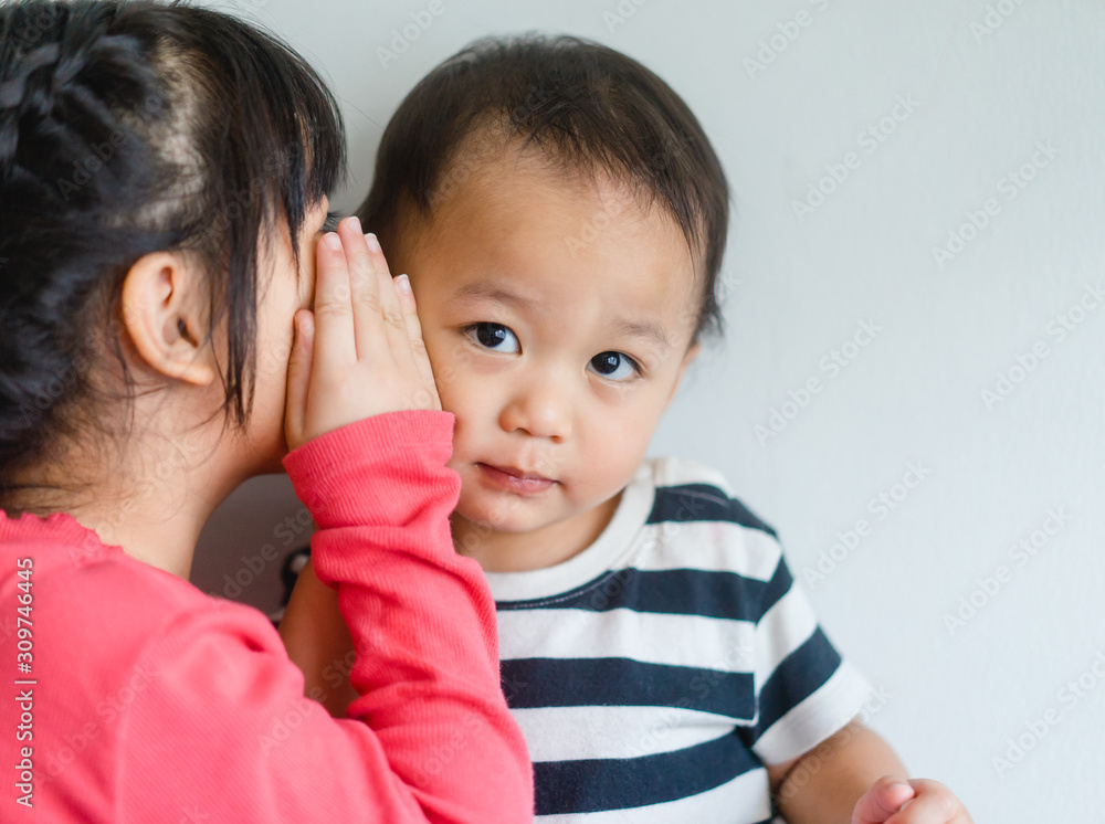 小妹妹和她的小弟弟窃窃私语，讲秘密。蹒跚学步的孩子遇到了新的兄弟姐妹。可爱