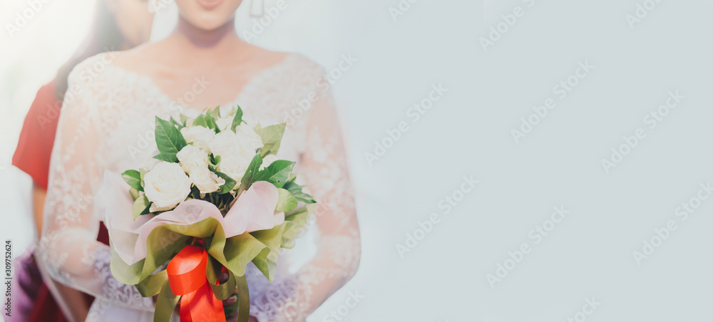 Happy Beautiful asian bride holding wedding bouquet in Church.